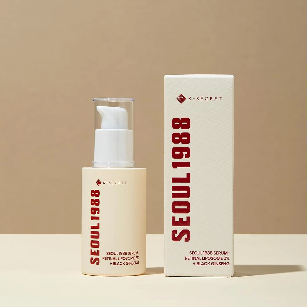 A bottle of serum next to a box.