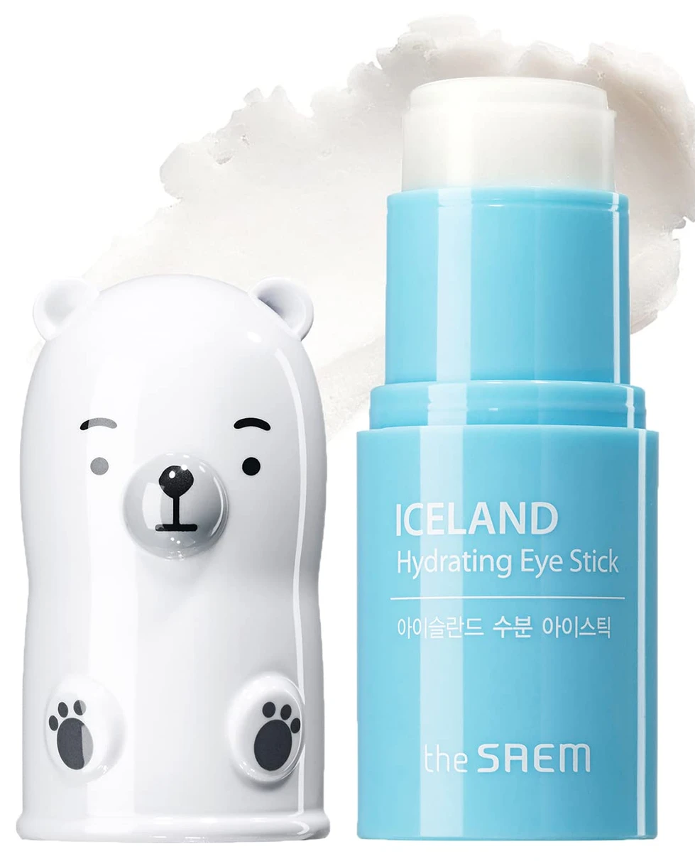 A white bear is next to some blue liquid